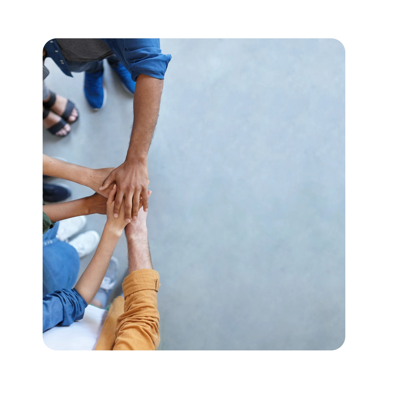 a group of people putting their hands on top of each other