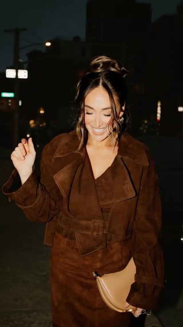 a woman in a brown coat