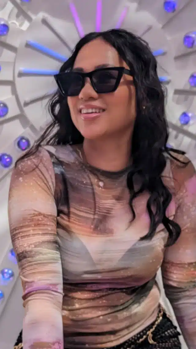 a woman wearing sunglasses and a shirt