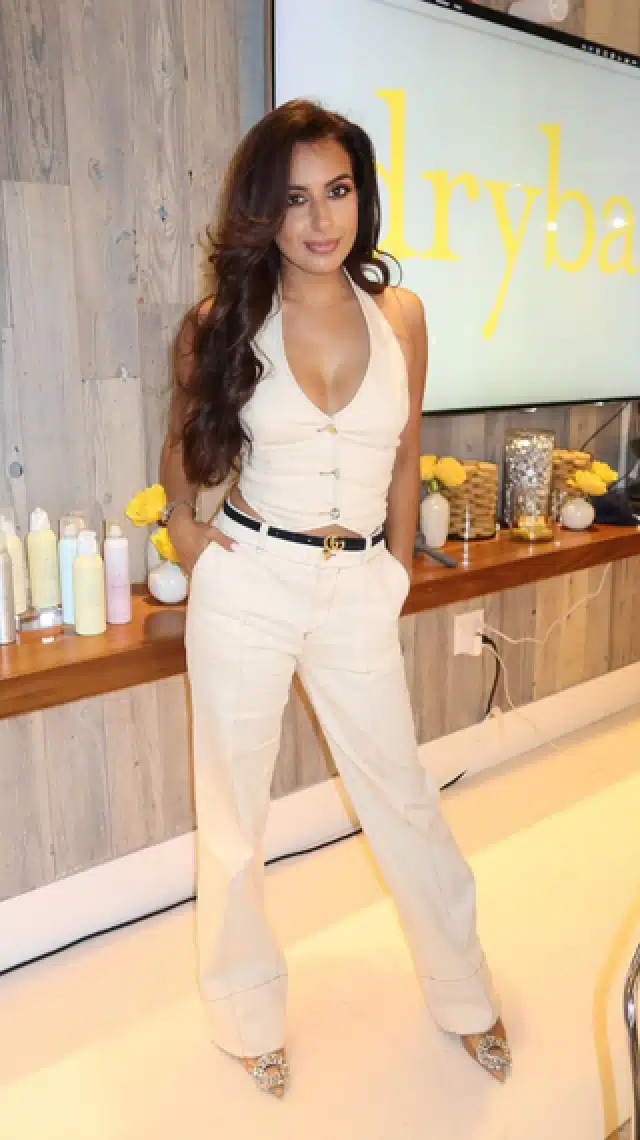 a woman standing in front of a screen